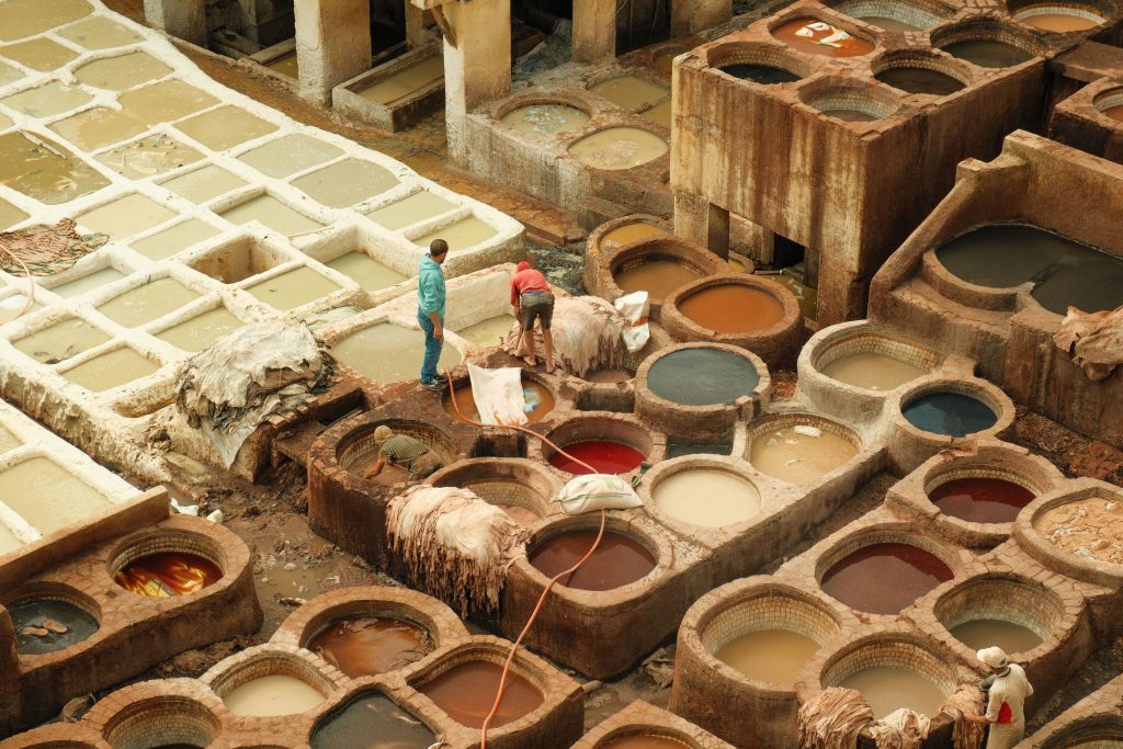 Entreprises Aerial view of a traditional leather tannery in Fes, Morocco, showcasing colorful dye pits.